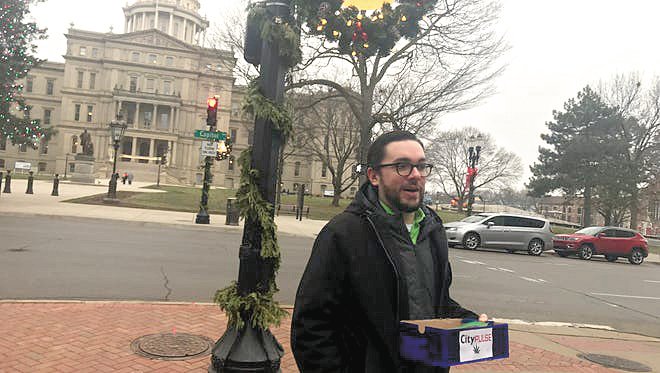 Kyle Kaminski handing out joints near the State Capitol Building.